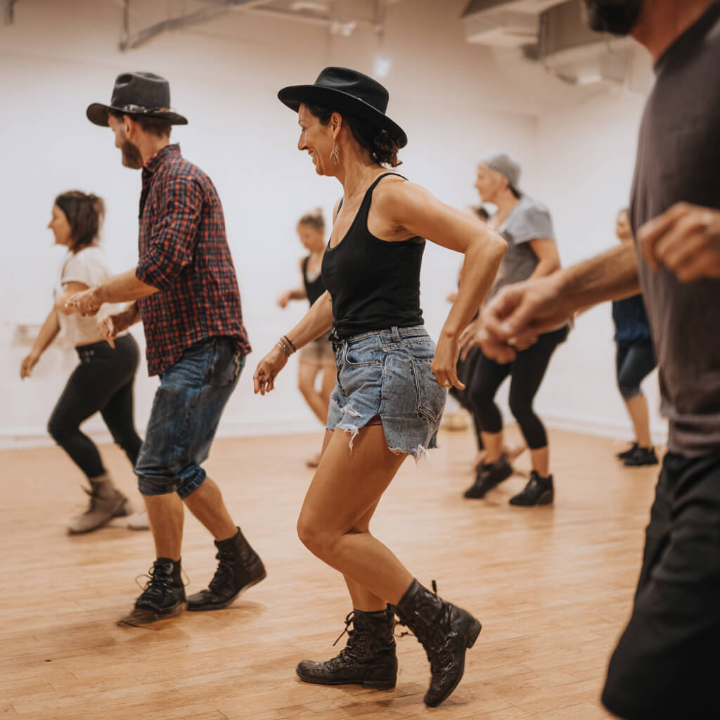 Line dancing classes Gloucester instructors teaching country western dance moves by the historic River Severn